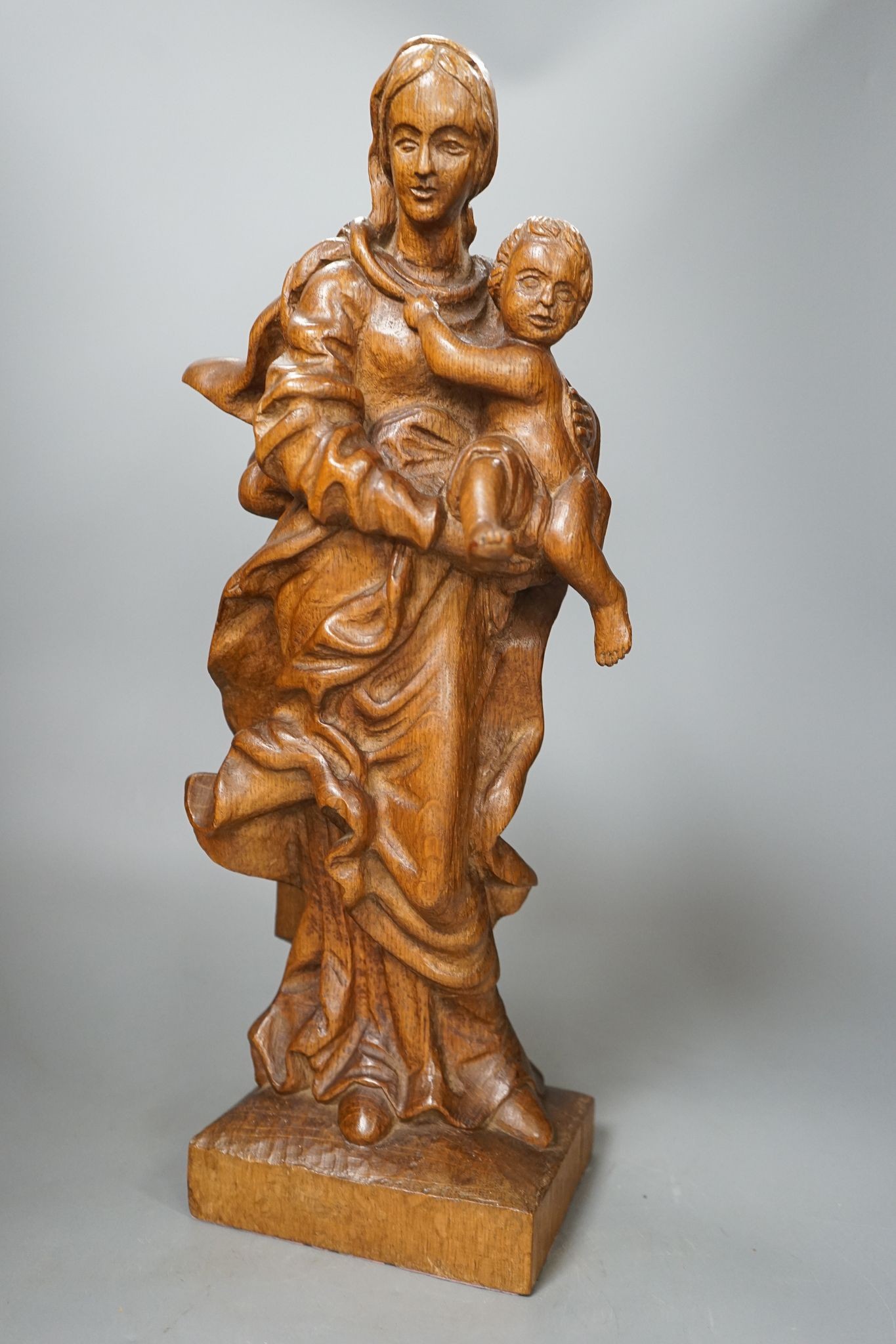 A 19th century carved oak Madonna and child, 49cm